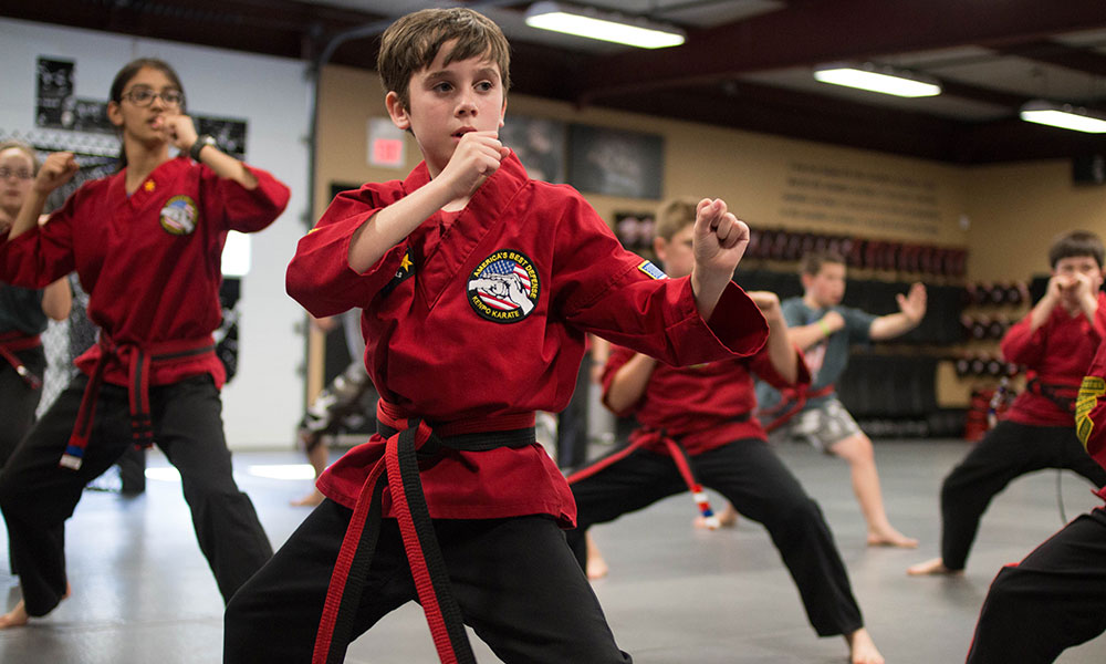 Young martial arts students practicing in a training facility